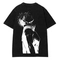 A black short-sleeve t-shirt laid flat on a light gray wood-textured background, featuring a large white graphic print of an anime-style character on the back.