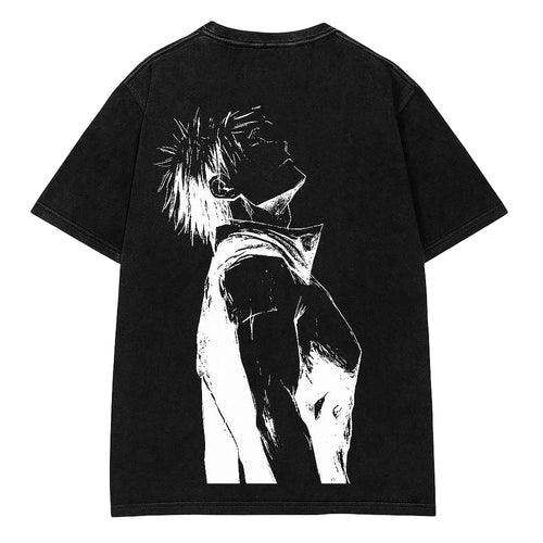 A black short-sleeve t-shirt laid flat on a light gray wood-textured background, featuring a large white graphic print of an anime-style character on the back.