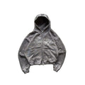 Gray hoodie with 'Lifecycles' text on a textured surface with ivy