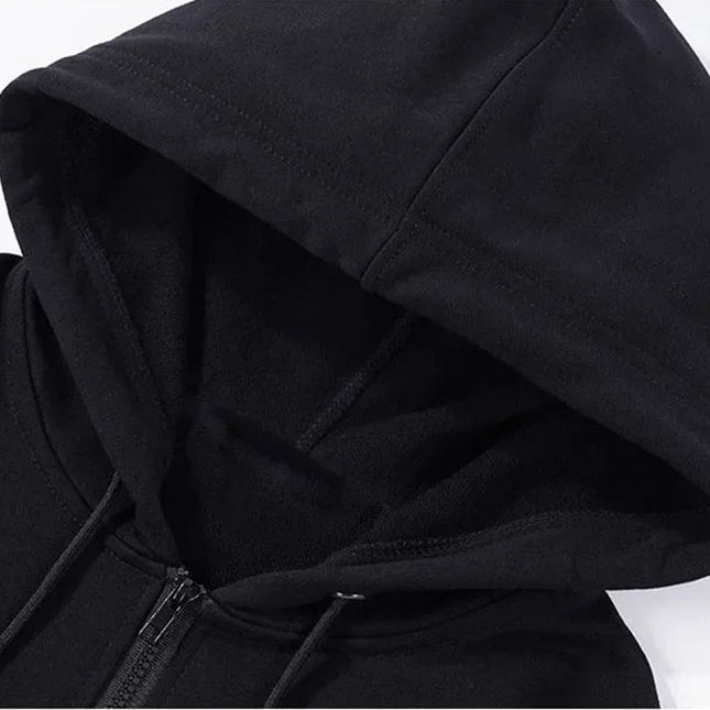 Close-up of a black hooded jacket on a white background