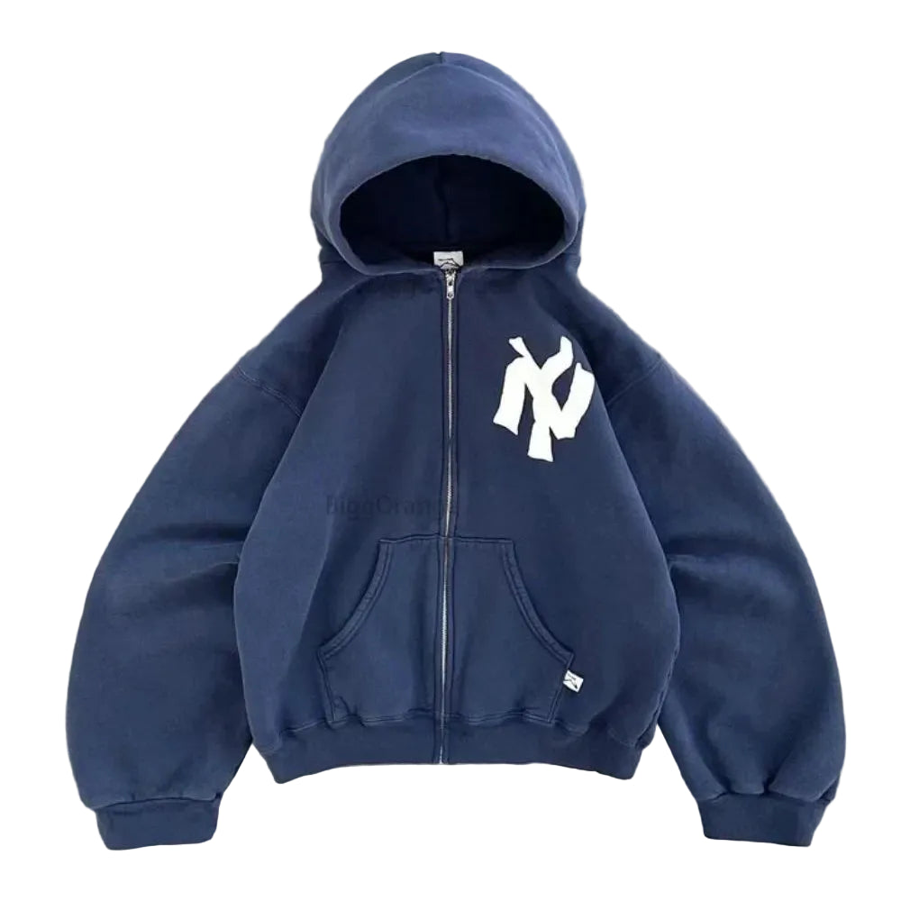 Navy blue hoodie with a logo on a gray concrete surface