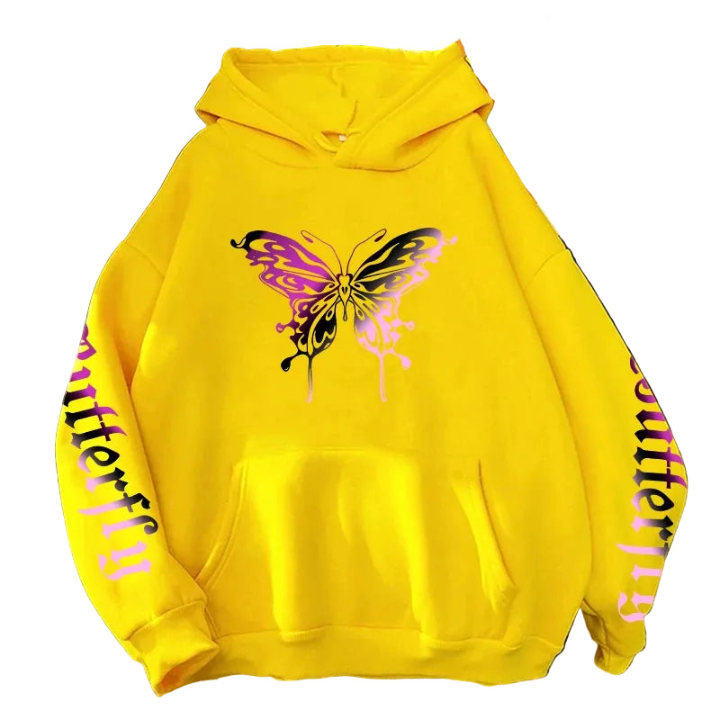 Yellow hoodie with butterfly design on a textured surface