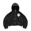 Black hoodie with a white logo on a gray surface