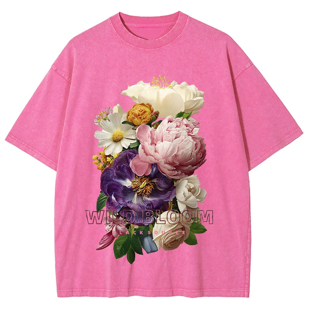 Pink t-shirt with a colorful floral design on a white background