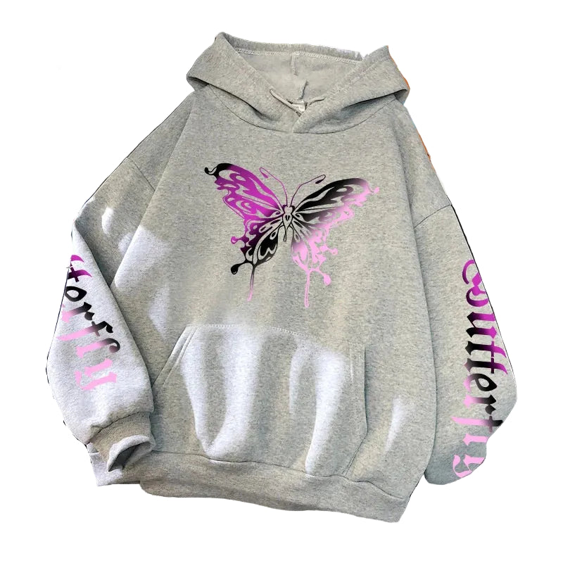 Gray hoodie with butterfly design and text on a surface with books and shoes.