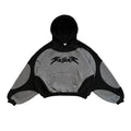 Black and gray hoodie with a logo on a textured surface
