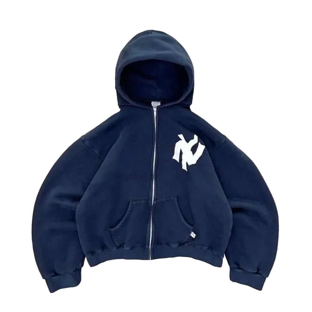 Navy blue hoodie with a logo on a gray concrete surface