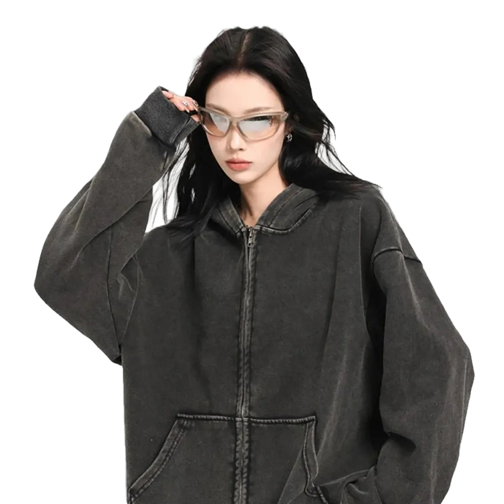 Person wearing a black cotton washed zipper hoodie against a gray background